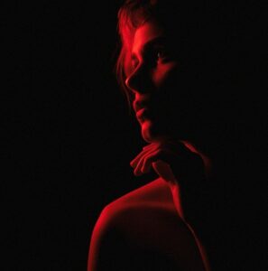 photo of a woman under red lighting