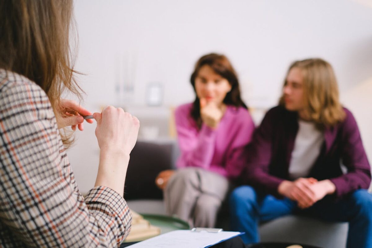 A couple attending a relationship counseling session, discussing their concerns with a professional therapist.
