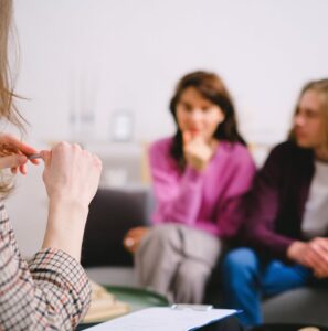 A couple attending a relationship counseling session, discussing their concerns with a professional therapist.
