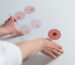 Hands sorting illustration cards showing diverse breast and nipple shapes for body awareness and health education