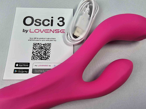 Lovense Osci 3 G-spot vibrator with user manual and charging cable, app-controlled for precision stimulation.