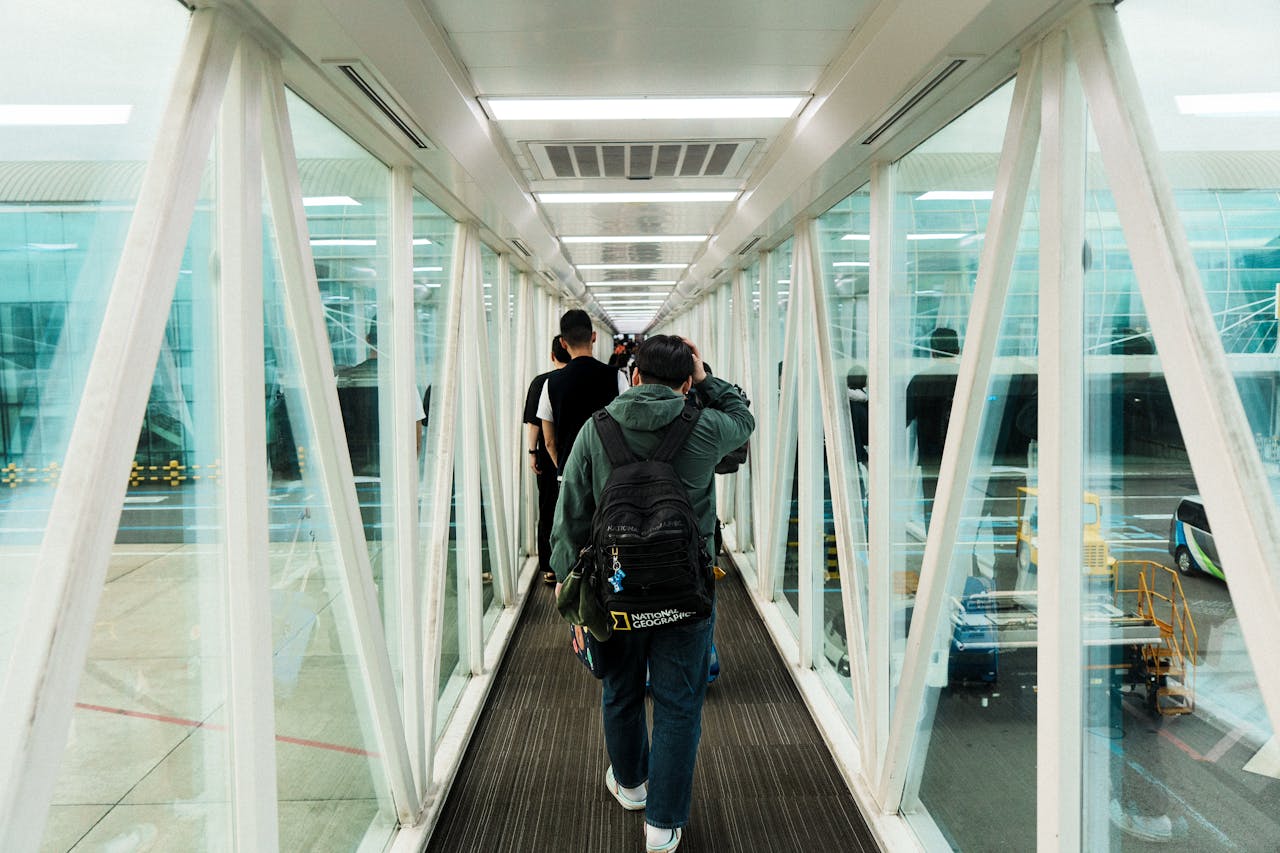 Travelers walking through an airport jetway. The goal for every philippines ldr is the eventual reunion and closing the distance.