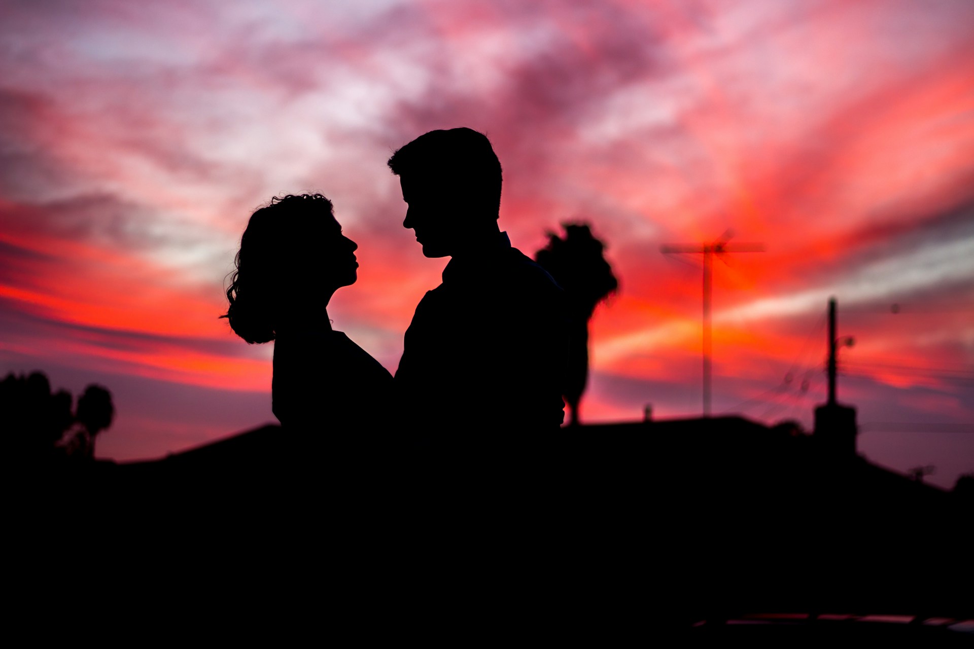Silhouette of a couple embracing at sunset. A successful filipino long distance relationship ends with being together in person.