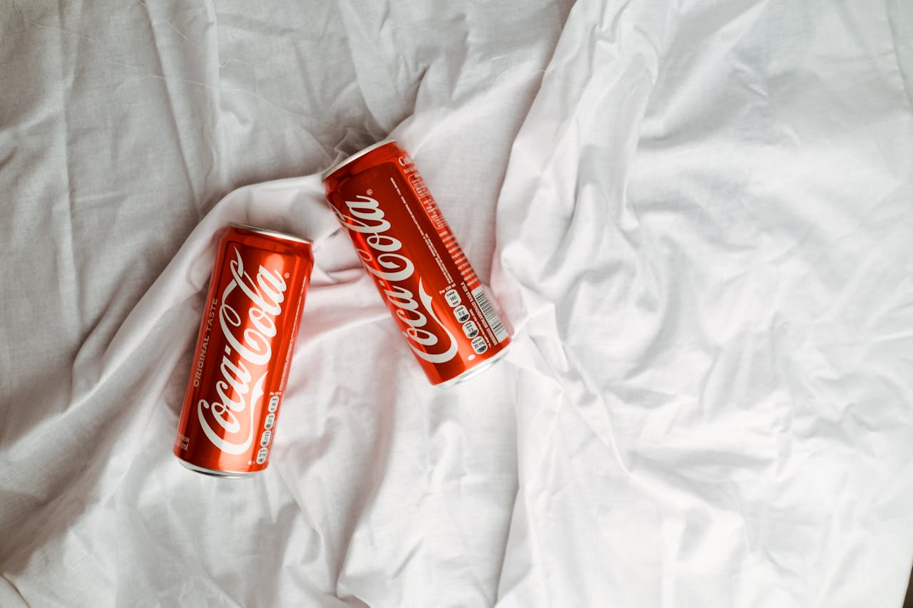 Two cans of soda on white sheets. This refers to common urban legends about sex and home remedies found in Filipino folklore.