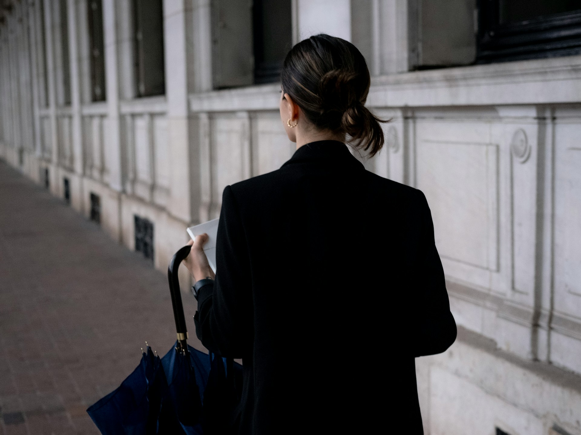 A professional woman walks down a public sidewalk, highlighting the need for safety in public spaces under the Bawal Bastos Law.